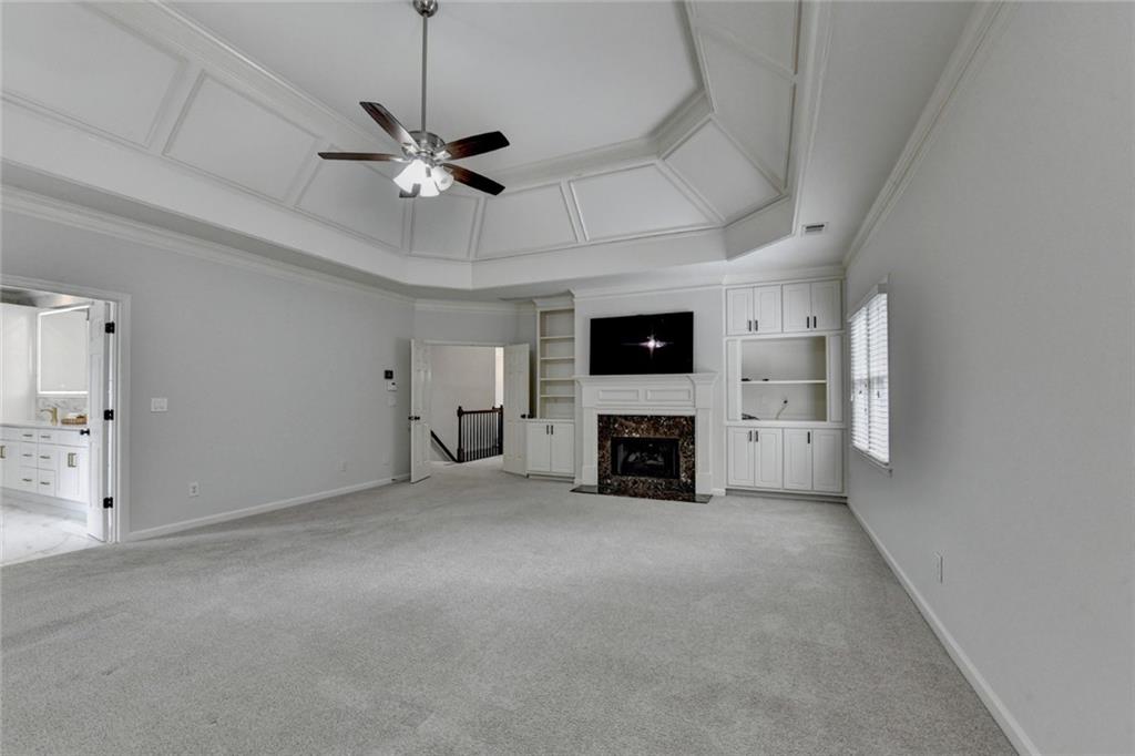 855 Autumn Close Alpharetta, GA 30004 - Photo 79 of 154 a view of an empty room with a fireplace and a window