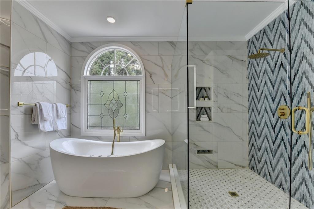 855 Autumn Close Alpharetta, GA 30004 - Photo 91 of 154 a bathroom with a bathtub and a shower