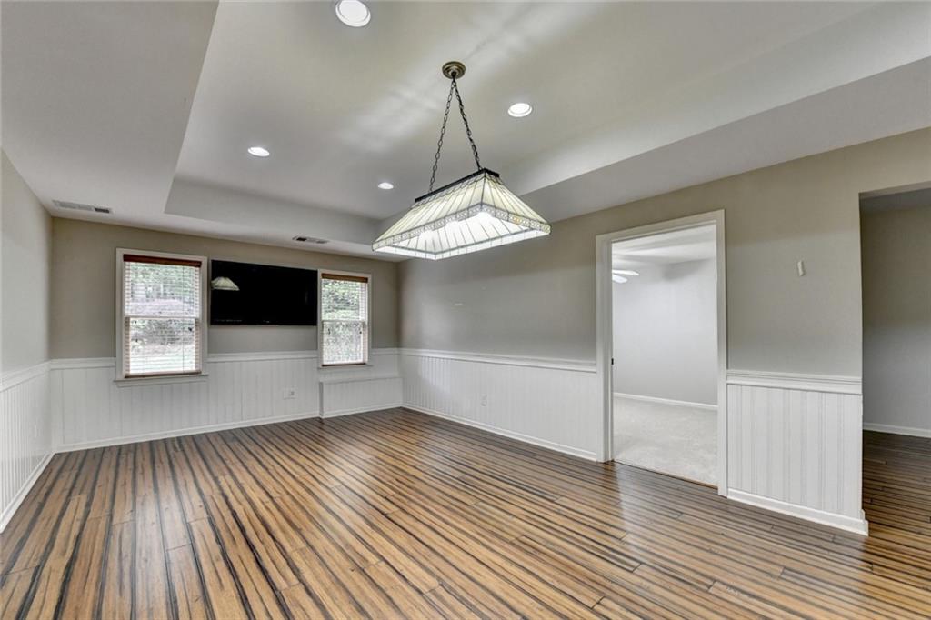 855 Autumn Close Alpharetta, GA 30004 - Photo 100 of 154 a view of a room with wooden floor staircase and a kitchen space