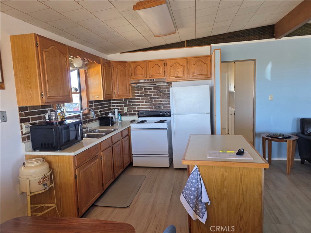 5566 Oleta Road Landers, CA 92285 - Photo 12 of 40 a kitchen with stainless steel appliances granite countertop a sink counter space and a window