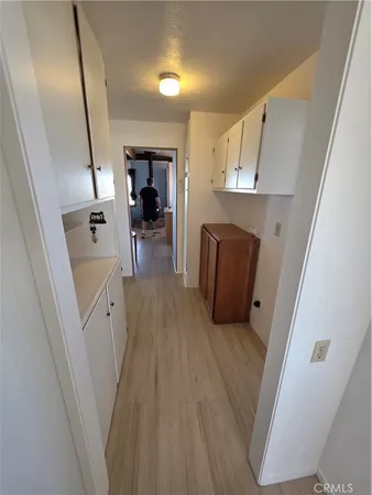 a view of hallway with stairs and wooden floor