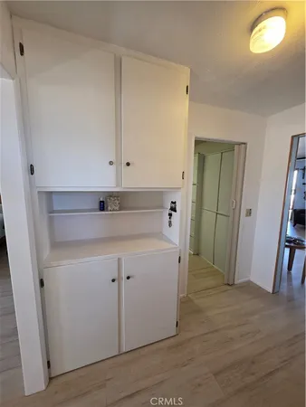 a view of a kitchen with closet and wooden floor