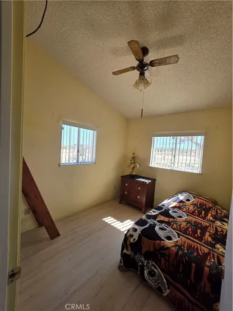 a bedroom with bed and window