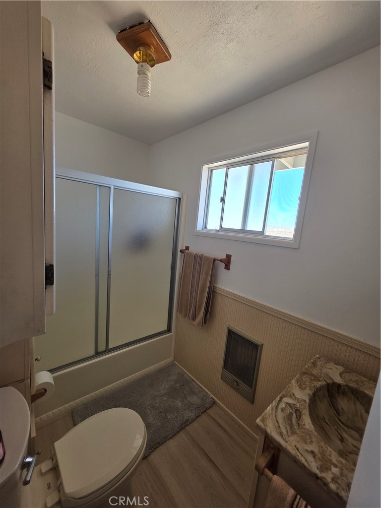 5566 Oleta Road Landers, CA 92285 - Photo 24 of 40 a bathroom with a toilet a sink and mirror