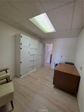 a room with a bed and cabinets