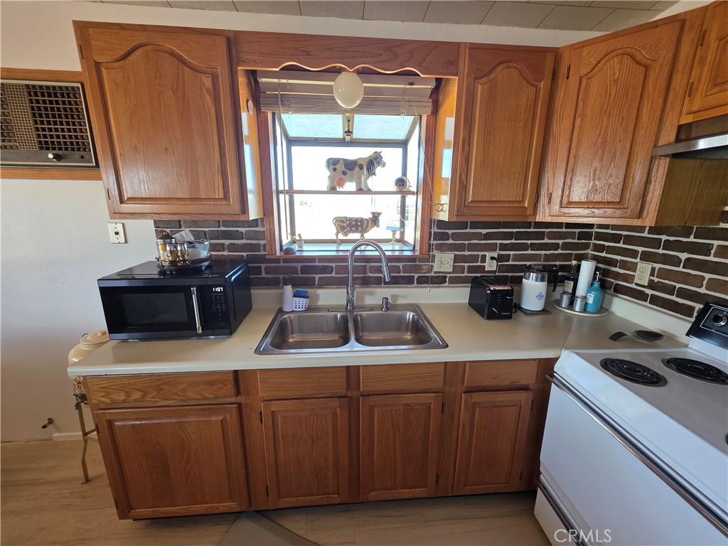 5566 Oleta Road Landers, CA 92285 - Photo 10 of 40 a kitchen with a sink and cabinets