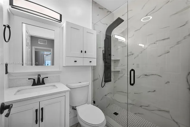 a metallic refrigerator freezer sitting in a kitchen