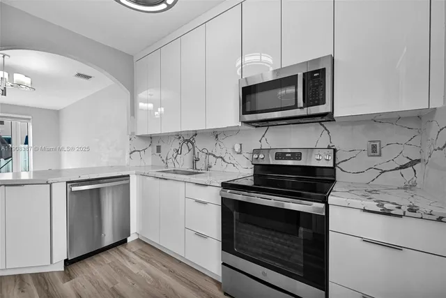 a view of a room with wooden floor