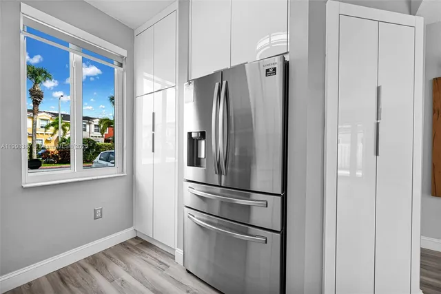 a bedroom with a bed potted plant and a window