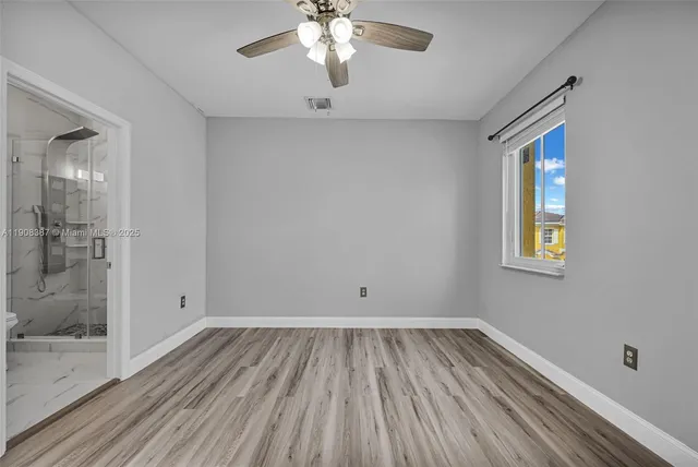 a bathroom with a granite countertop toilet sink and shower