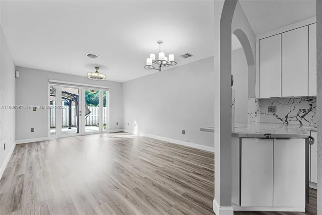 a view of kitchen and hallway with wooden floor