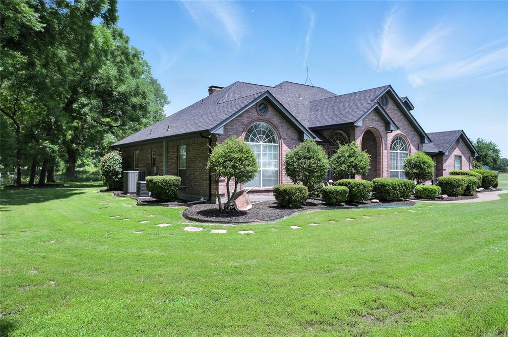 a front view of a house with garden and porch