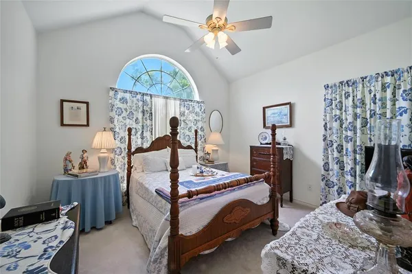 a bedroom with bed and a chandelier