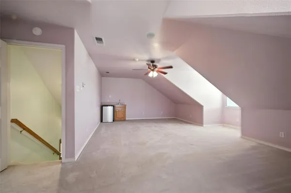 a view of a big room with closet and a ceiling fan