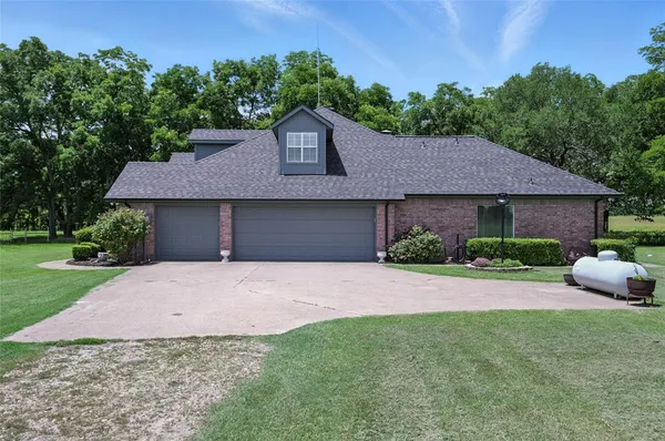 a front view of a house with a garden and yard