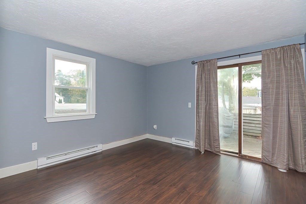 12 Oxbow Road Charlton, MA 01507 - Photo 21 of 40 a view of an empty room with wooden floor and a window