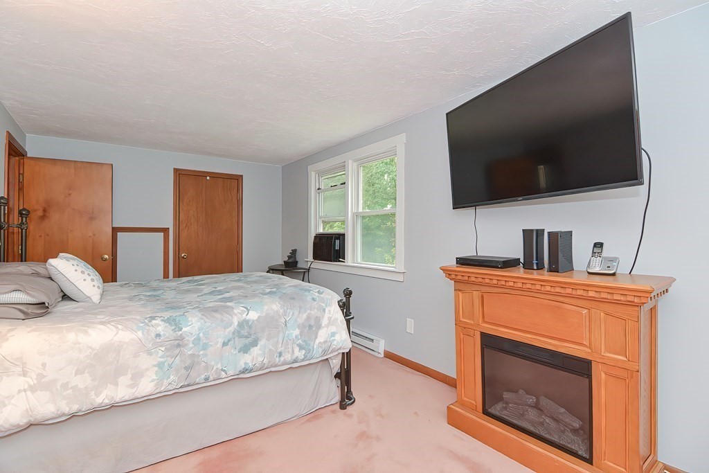 12 Oxbow Road Charlton, MA 01507 - Photo 26 of 40 a bedroom with a bed and a flat screen tv