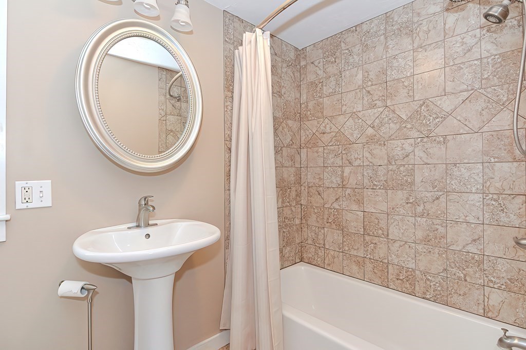 12 Oxbow Road Charlton, MA 01507 - Photo 29 of 40 a bathroom with a sink a mirror and a bathtub