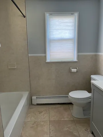 a bathroom with a toilet and a bathtub