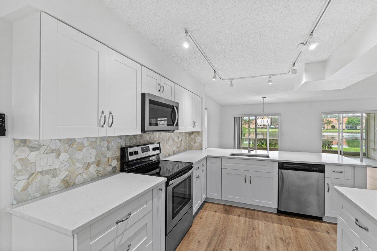 a kitchen with a sink stove and microwave