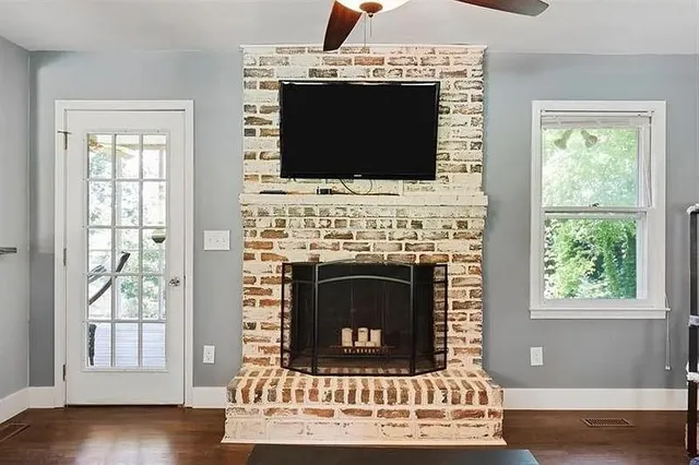 a living room with a fireplace and a flat screen tv