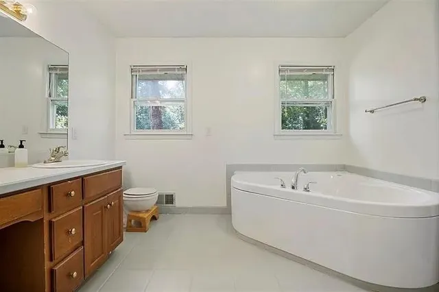 a white bath tub sitting next to a white sink