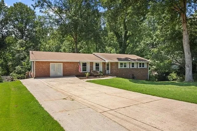 a front view of a house with yard and green space