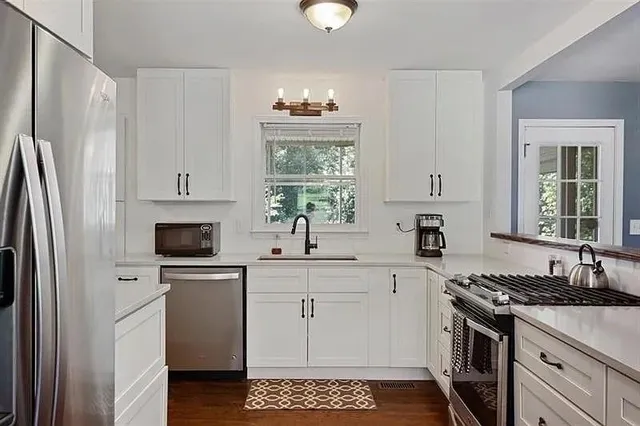 a kitchen with a sink stove and refrigerator