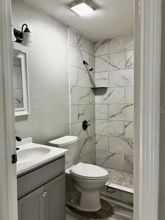 a bathroom with a sink toilet and shower