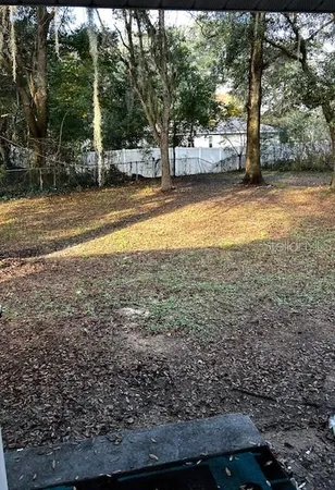 a view of a swimming pool and trees in the background