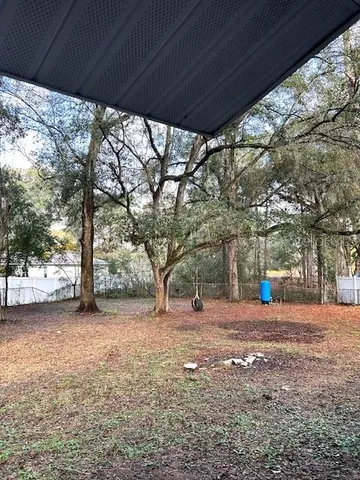a view of a yard with a tree