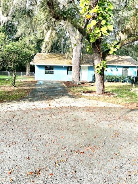 37 Cedar Tree Terrace Ocala, FL 34472 - Photo 21 of 21 a front view of a house with a yard and a large tree