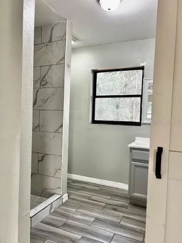 a bathroom with a shower and a sink