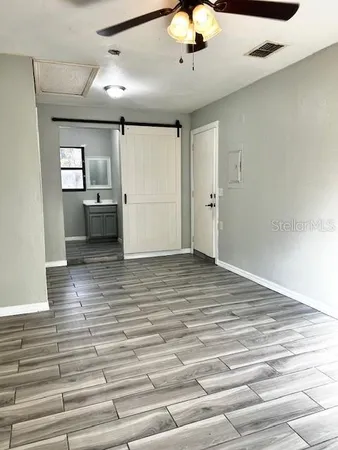a view of a room with cabinet and mirrors