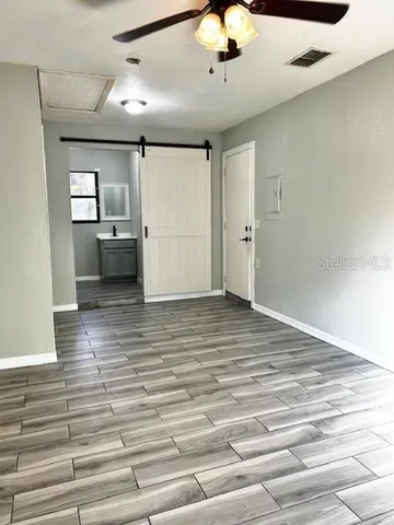 a view of a room with cabinet and mirrors