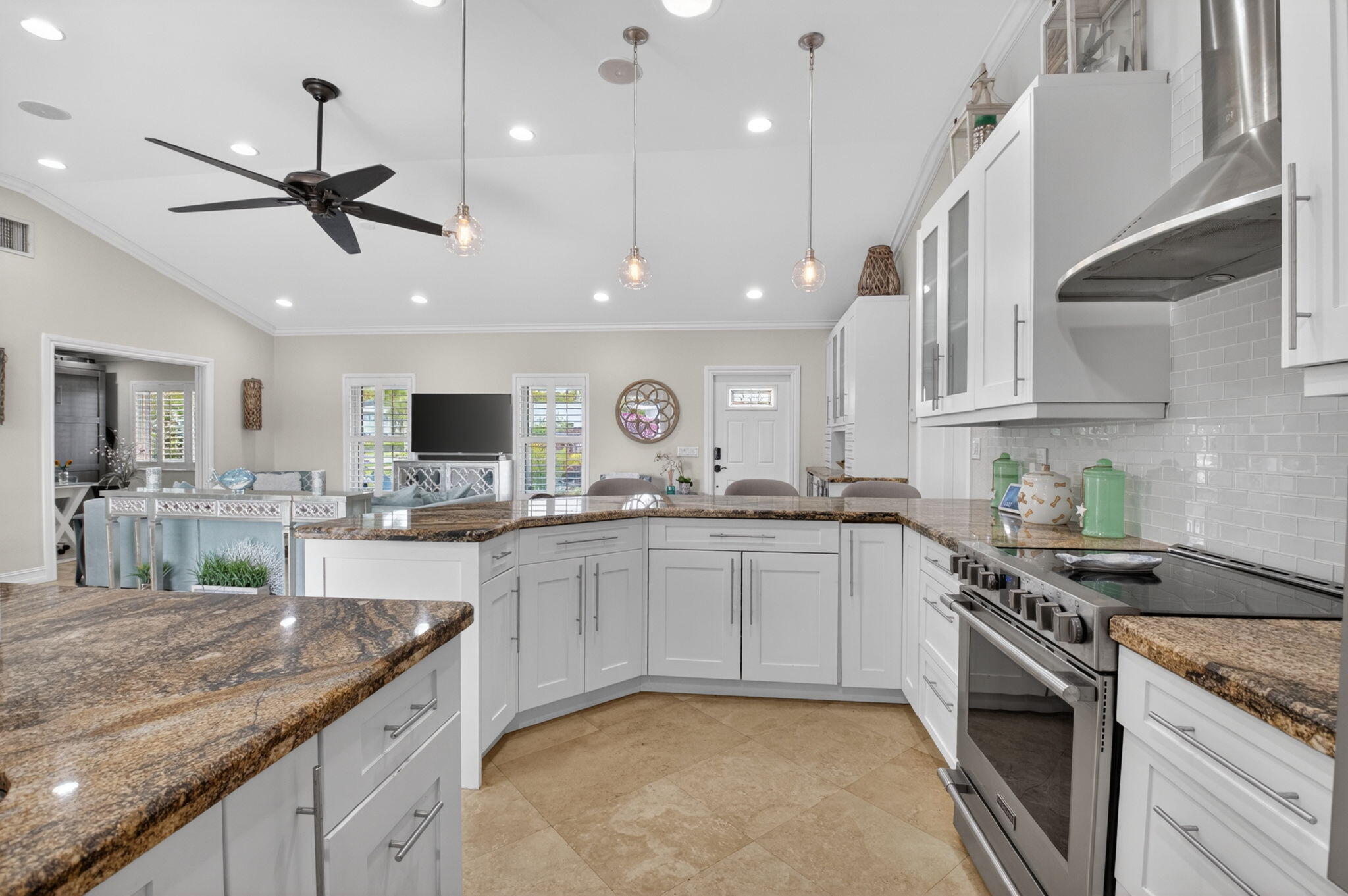 5800 Northeast 7th Avenue Boca Raton, FL 33487 - Photo 17 of 61 a kitchen with stainless steel appliances granite countertop a sink and stove top oven