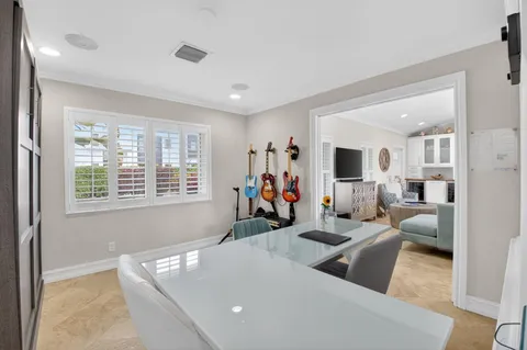 a bedroom with a bed window and a flat screen tv