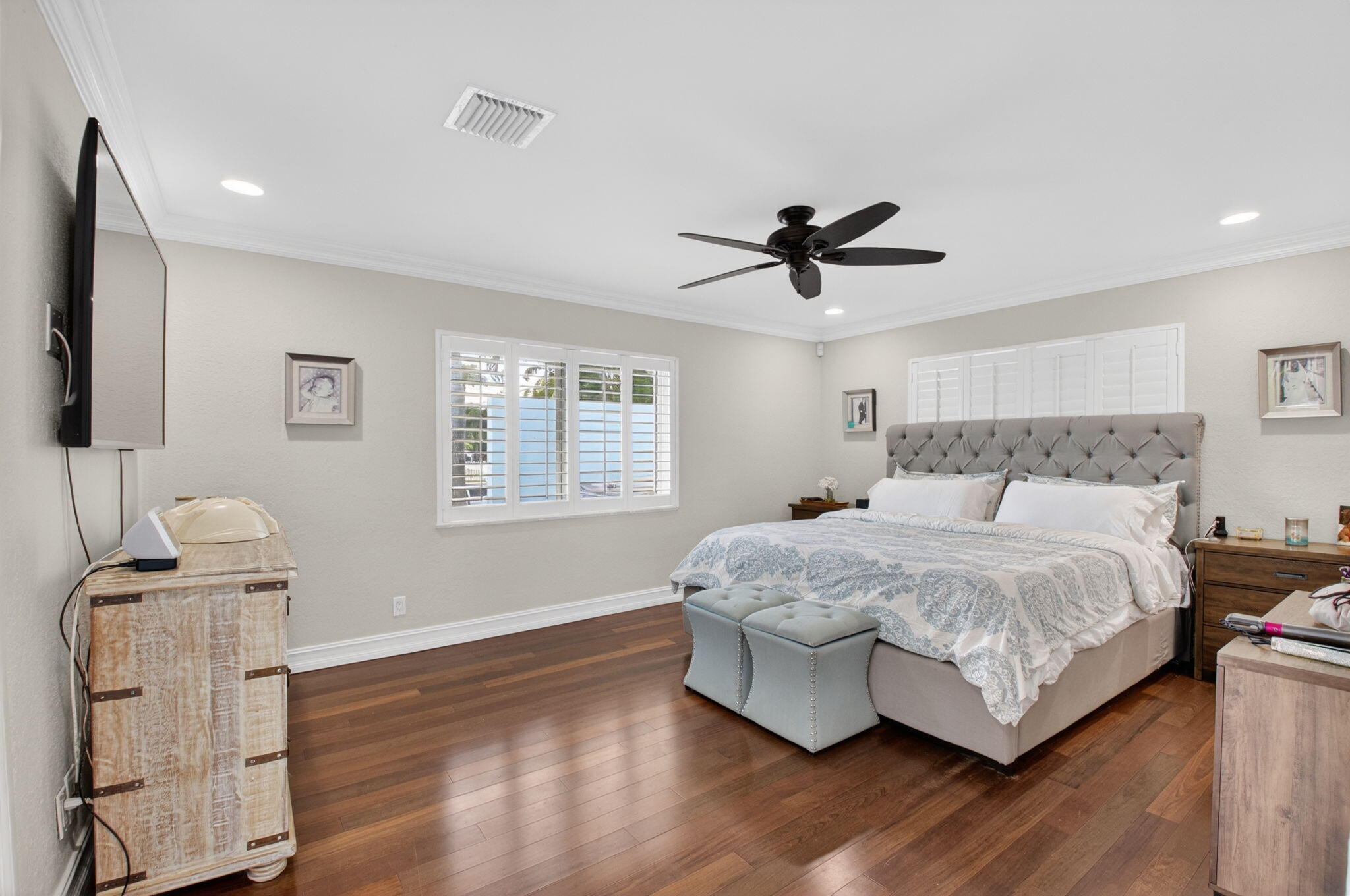 5800 Northeast 7th Avenue Boca Raton, FL 33487 - Photo 25 of 61 a bedroom with a bed and wooden floor