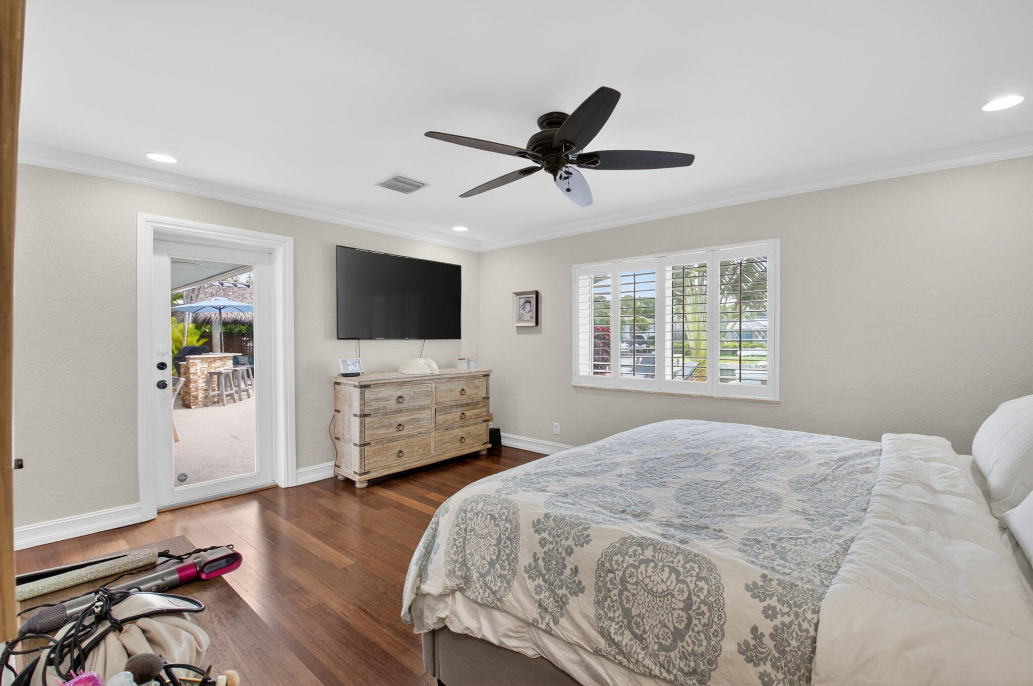 5800 Northeast 7th Avenue Boca Raton, FL 33487 - Photo 27 of 61 a bedroom with a bed window and a flat screen tv