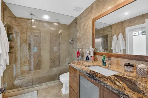 a view of a house with a patio and a yard