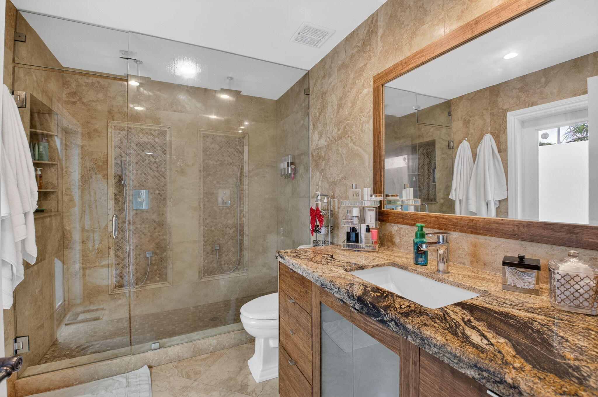 5800 Northeast 7th Avenue Boca Raton, FL 33487 - Photo 28 of 61 a bathroom with a granite countertop sink a toilet a mirror and shower