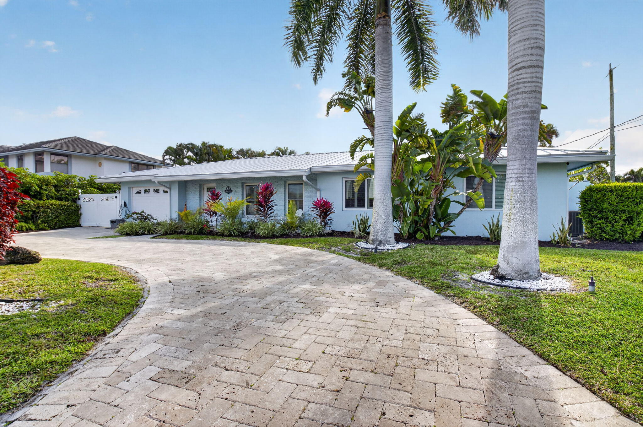 5800 Northeast 7th Avenue Boca Raton, FL 33487 - Photo 3 of 61 a front view of house with yard and green space