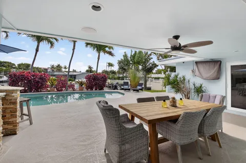 a view of swimming pool with outdoor seating and couches
