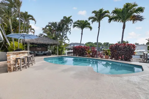a view of a house with swimming pool and sitting area