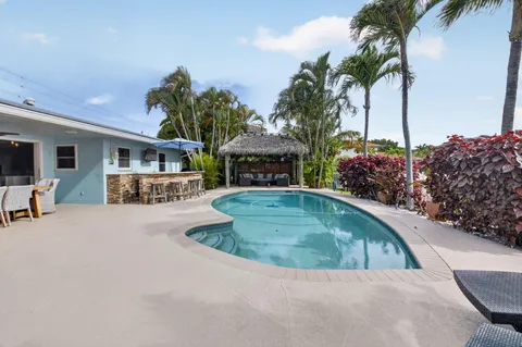a view of an house with backyard and sitting area