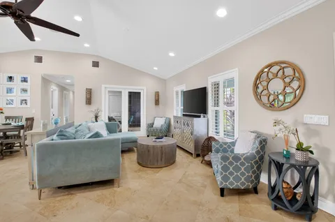 a dining room with furniture and a potted plant