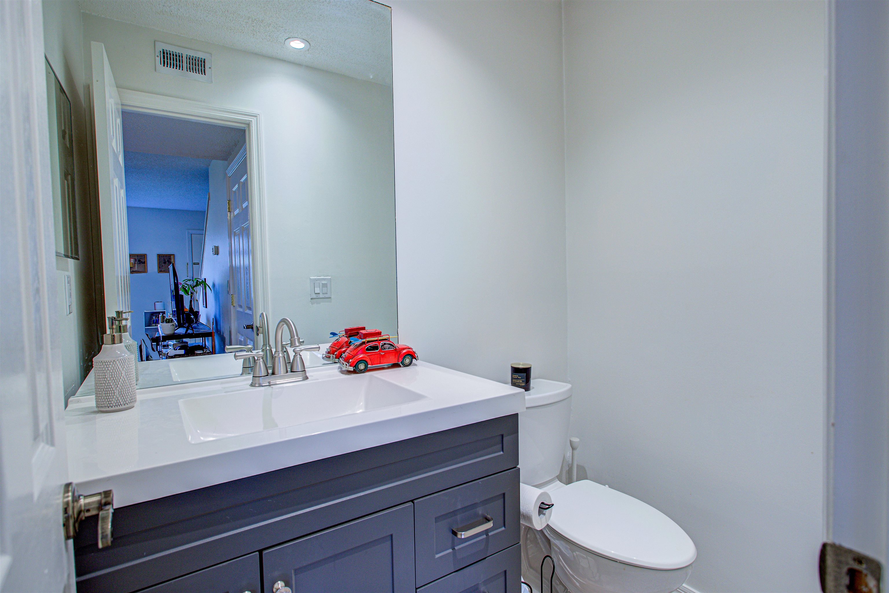 118 Rio Del Mar Street St. Augustine, FL 32080 - Photo 12 of 24 a bathroom with a sink vanity mirror and toilet