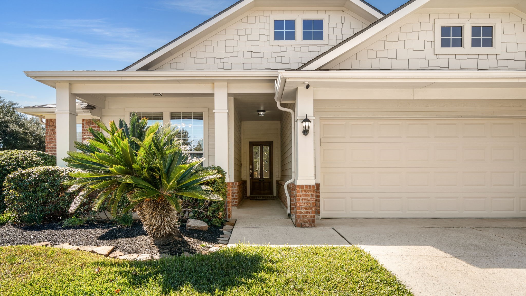 a front view of a house with garden