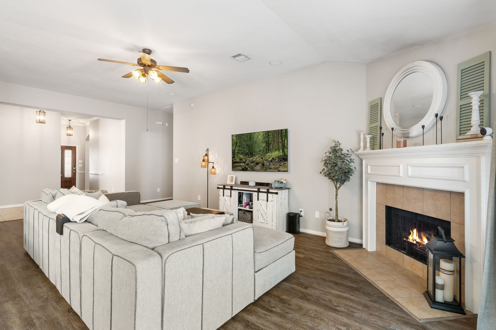 20903 Manon Lane Spring, TX 77388 - Photo 11 of 31 a living room with furniture a fireplace and a flat screen tv