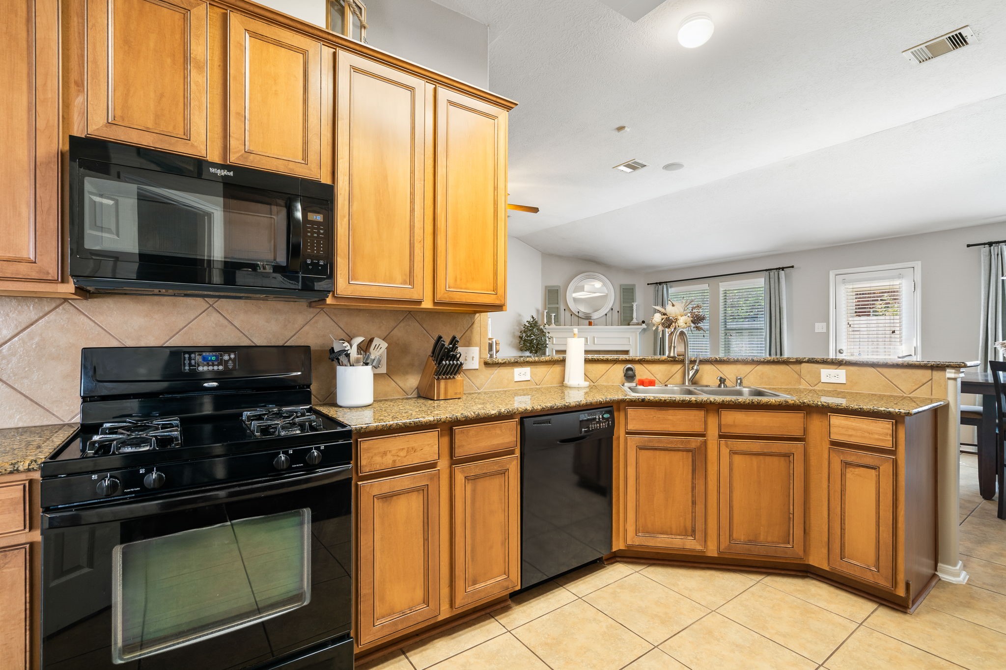 20903 Manon Lane Spring, TX 77388 - Photo 16 of 31 a kitchen with a stove and a microwave